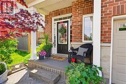 Brick and stone facade featuring a portico entry with white columns - 