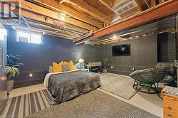 Expansive finished basement with exposed wood joists and steel beams - 