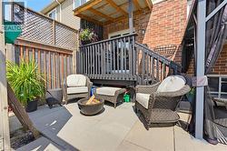 Private backyard patio with concrete pavers and a wood privacy fence - 