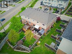 Expansive rear yard featuring lush green lawn and mature trees - 