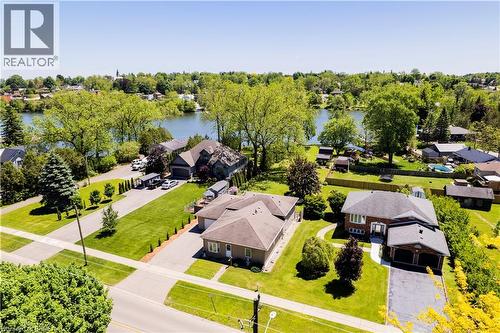Aerial perspective showcasing a residential property with a waterfront setting - 100 Mechanic Street W, Waterford, ON - Outdoor With View