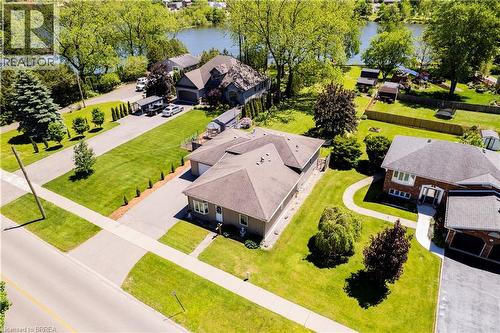Expansive property featuring a spacious driveway, mature trees, and a substantial green lawn - 100 Mechanic Street W, Waterford, ON - Outdoor
