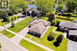Expansive property featuring a spacious driveway, mature trees, and a substantial green lawn - 