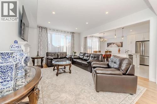 Living room featuring light hardwood / wood-style flooring and a notable chandelier - 53 Mackay Drive, Woodstock, ON - Indoor Photo Showing Living Room