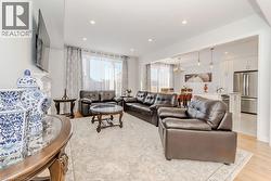 Living room featuring light hardwood / wood-style flooring and a notable chandelier - 