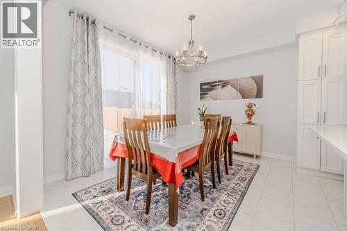 Tiled dining area featuring a chandelier - 53 Mackay Drive, Woodstock, ON - Indoor Photo Showing Dining Room