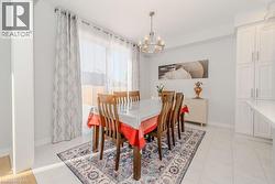 Tiled dining area featuring a chandelier - 