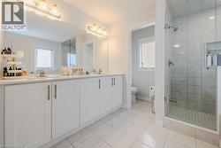 Bathroom with tile patterned flooring, vanity, toilet, and plenty of natural light - 