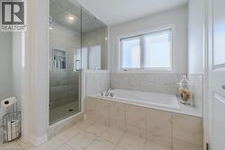 Bathroom with tile patterned flooring and plus walk in shower - 