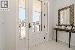Doorway to outside with light tile patterned flooring - 