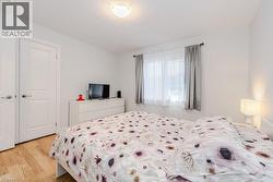Bedroom with a closet and light hardwood / wood-style flooring - 