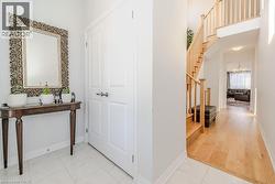 Hall featuring light tile patterned floors and a high ceiling - 