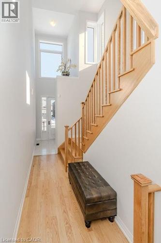 Stairway featuring a towering ceiling and wood-type flooring - 53 Mackay Drive, Woodstock, ON - Indoor Photo Showing Other Room