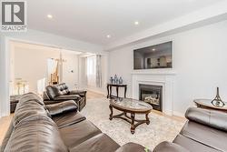 Living room featuring an inviting chandelier and light hardwood / wood-style flooring - 