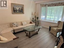 Spacious living area featuring light wood-finish flooring - 