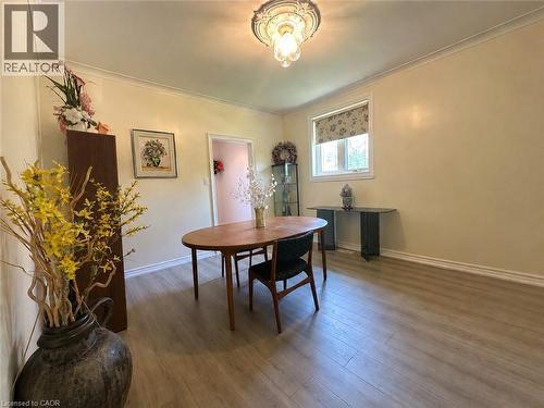 Spacious room featuring light wood-finish flooring, a window with a patterned roller shade, and crown molding - 1571 Muir Road, Mississauga, ON 