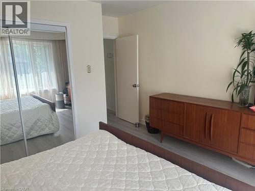 Bedroom featuring light wood-finish flooring and neutral wall tones - 1571 Muir Road, Mississauga, ON 