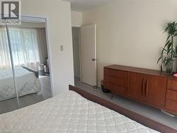 Bedroom featuring light wood-finish flooring and neutral wall tones - 