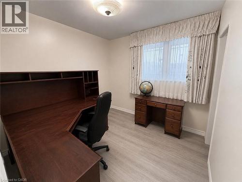 Room featuring wood-finish flooring and a ceiling-mounted light fixture - 1571 Muir Road, Mississauga, ON 