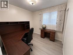 Room featuring wood-finish flooring and a ceiling-mounted light fixture - 