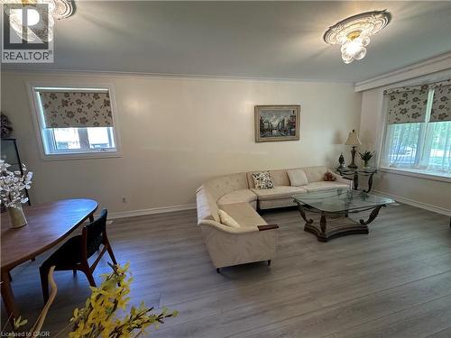 Open concept living space featuring light wood-finish flooring and crown molding - 1571 Muir Road, Mississauga, ON 