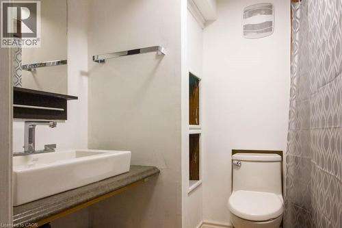 Contemporary bathroom featuring a rectangular vessel sink, wall-mounted faucet, and a wall-mounted mirror - 30 Eastvale Place, Hamilton, ON - Indoor Photo Showing Bathroom