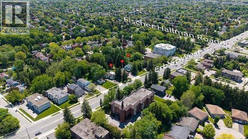 Aerial perspective of a residential area featuring mature trees and established properties - 391 Erb Street, Waterloo, ON 