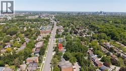 Aerial perspective showcasing a residential neighborhood with extensive tree canopies - 