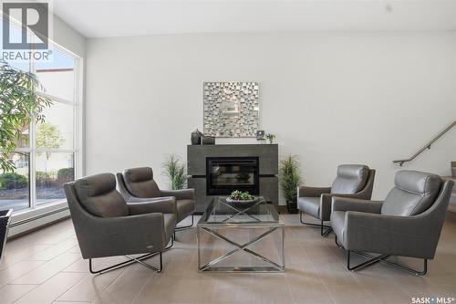 303 1025 Moss Avenue, Saskatoon, SK - Indoor Photo Showing Living Room With Fireplace