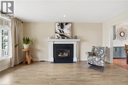 Sitting room with light wood-style floors, a tiled fireplace, and recessed lighting - 56 Mccaffery Crescent, St. Catharines, ON - Indoor Photo Showing Living Room With Fireplace