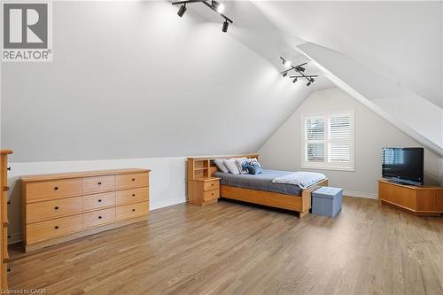 Bedroom featuring track lighting, light wood-style flooring, and vaulted ceiling - 56 Mccaffery Crescent, St. Catharines, ON - Indoor
