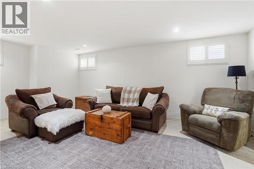 Living room featuring tile patterned floors - 56 Mccaffery Crescent, St. Catharines, ON - Indoor Photo Showing Basement
