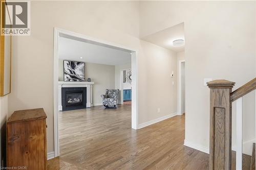 Hallway with light wood finished floors and baseboards - 56 Mccaffery Crescent, St. Catharines, ON - Indoor With Fireplace