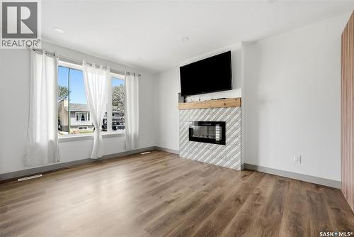 306 Howe Place, Regina, SK - Indoor Photo Showing Living Room With Fireplace