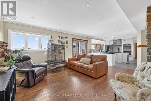 Family Room w/2 sided fireplace & walkout to deck - 10655 Sideroad 17, Brock, ON 