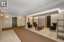 Building lobby featuring stone accent walls, recessed lighting, and a seating area with a low coffee table - 
