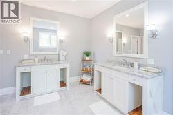 Dual white vanity sinks with marble countertops and chrome fixtures - 