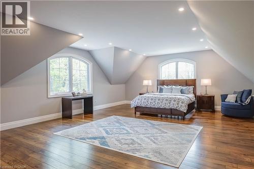 Expansive room featuring rich wood-finish flooring, recessed lighting, and two arched windows - 1521 Emily Lane, Severn, ON - Indoor Photo Showing Bedroom