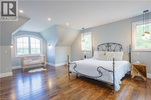Spacious bedroom with rich wood-finish flooring, recessed lighting, and a vaulted ceiling - 1521 Emily Lane, Severn, ON - Indoor Photo Showing Bedroom