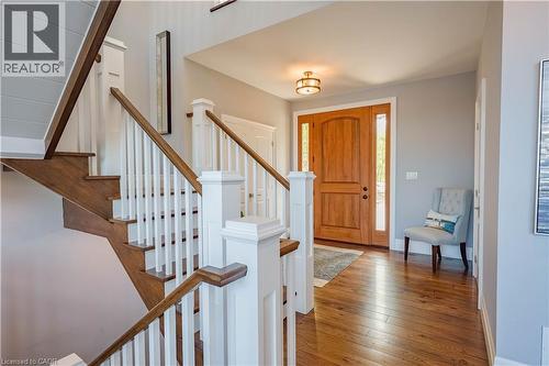Entry foyer showcasing wood-finish flooring and a wood-panel front door with sidelights - 1521 Emily Lane, Severn, ON - Indoor Photo Showing Other Room