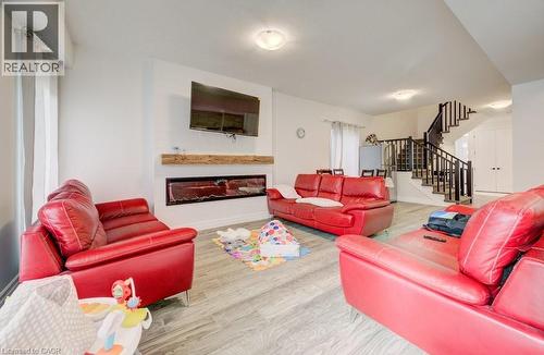 Living area featuring wood-finish flooring, a contemporary fireplace with a wood mantel, and recessed lighting - 32 Faith Street Unit# 19, Cambridge, ON - Indoor Photo Showing Living Room With Fireplace
