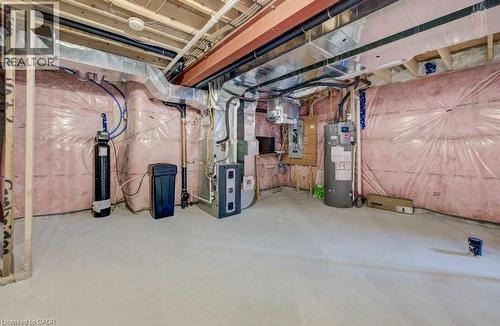 Unfinished basement featuring exposed wood framing, ceiling joists, and a concrete floor - 32 Faith Street Unit# 19, Cambridge, ON - Indoor Photo Showing Basement
