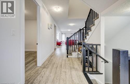 Hallway featuring wood-finish flooring, white walls, and recessed lighting - 32 Faith Street Unit# 19, Cambridge, ON - Indoor Photo Showing Other Room