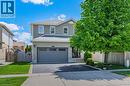 Two-story residence featuring a light gray brick exterior with a gray garage door - 63 Pentland Drive, Cambridge, ON 