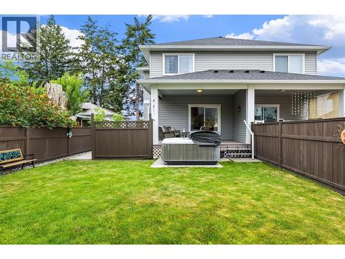 Green Space, Hot Tub, Covered Composite Deck and Full Fenced Yard - 827 Juniper Road, Kelowna, BC - Outdoor With Deck Patio Veranda