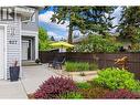 Private Entry - Flanked by Gardens Plots, Flagstone Patio and Concrete Walkways - 827 Juniper Road, Kelowna, BC  - Outdoor 