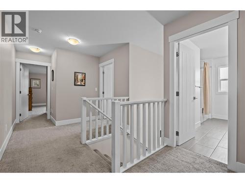 Spacious Halls to Upper Level Rooms - 827 Juniper Road, Kelowna, BC - Indoor Photo Showing Other Room