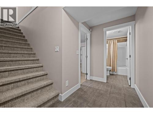 Finished Basement Landing to Full Bathroom and Open Concept Living Space - 827 Juniper Road, Kelowna, BC - Indoor Photo Showing Other Room
