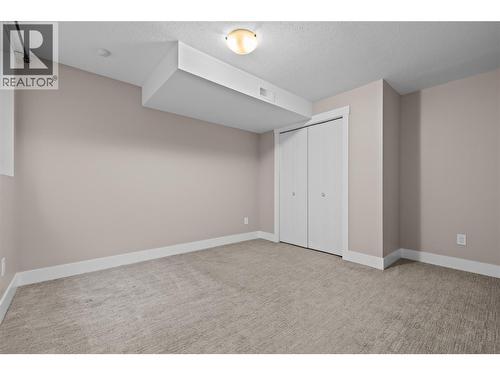 Large Bedroom with Closet and Window - 827 Juniper Road, Kelowna, BC - Indoor Photo Showing Other Room