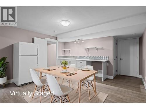 Virtually Staged - Kitchen, Dining Space with Fridge, Built-Ins and Double Sink - 827 Juniper Road, Kelowna, BC - Indoor Photo Showing Dining Room